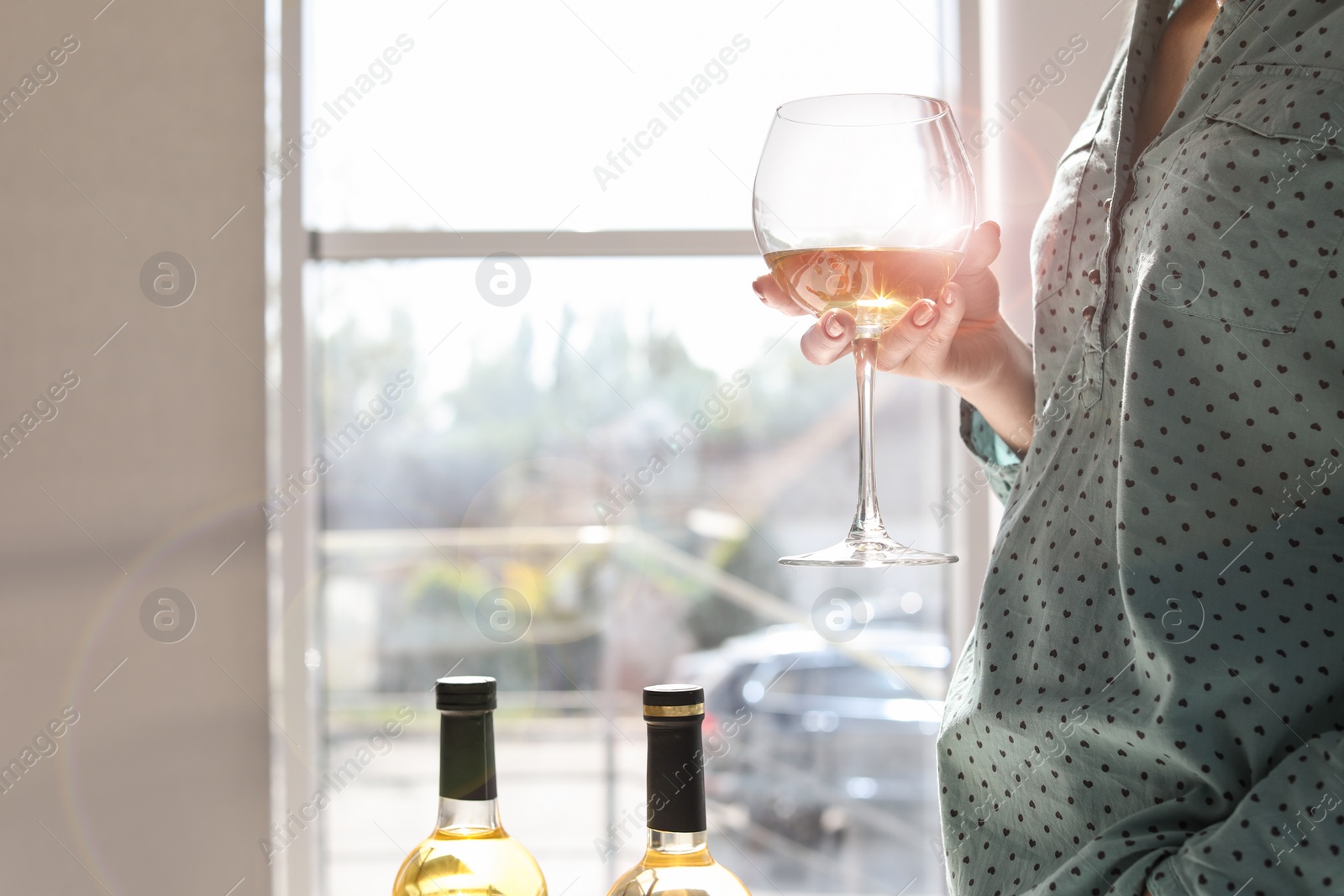 Photo of Woman with glass of delicious wine indoors