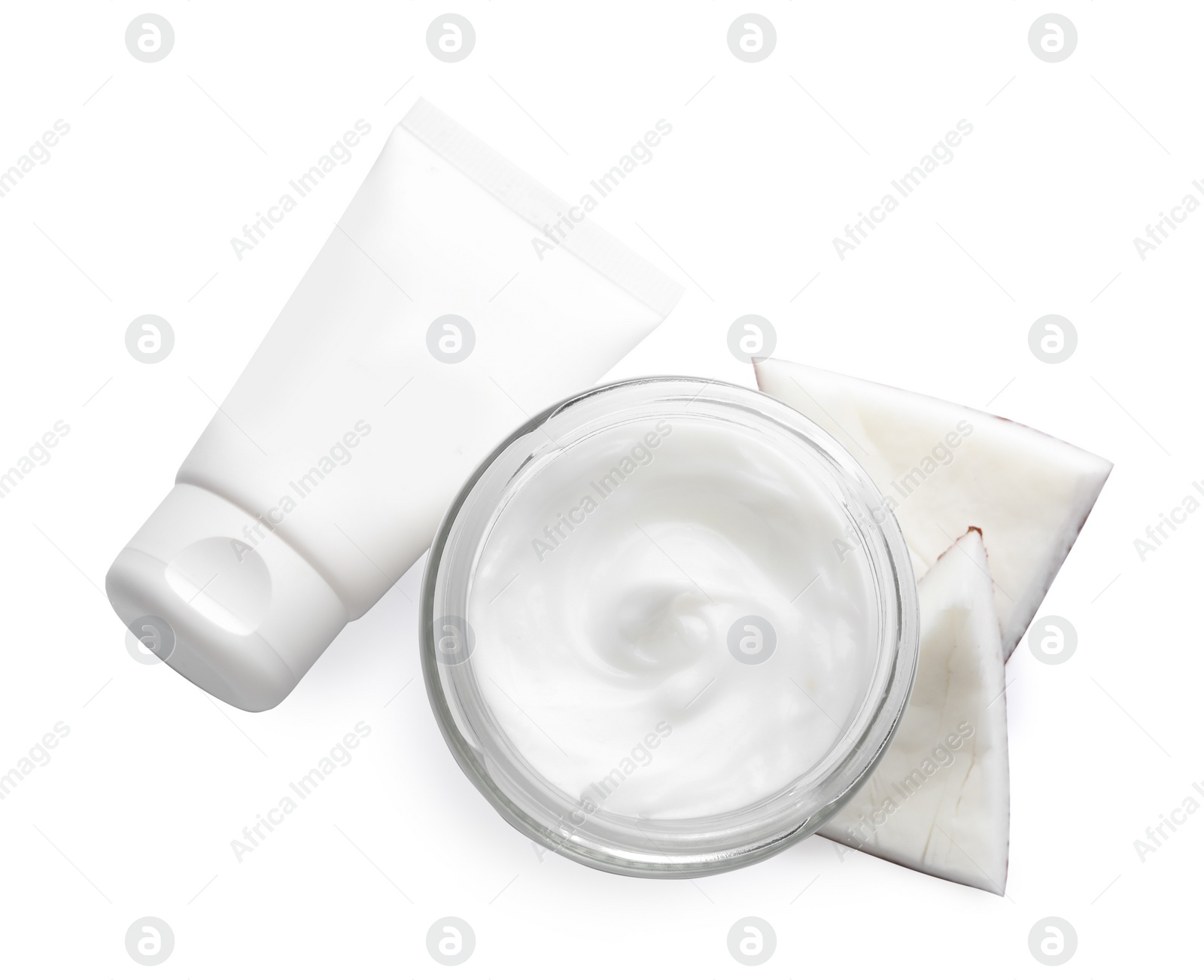 Photo of Different hand care cosmetic products and coconut pieces on white background, top view