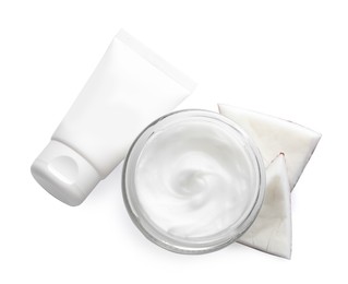 Photo of Different hand care cosmetic products and coconut pieces on white background, top view