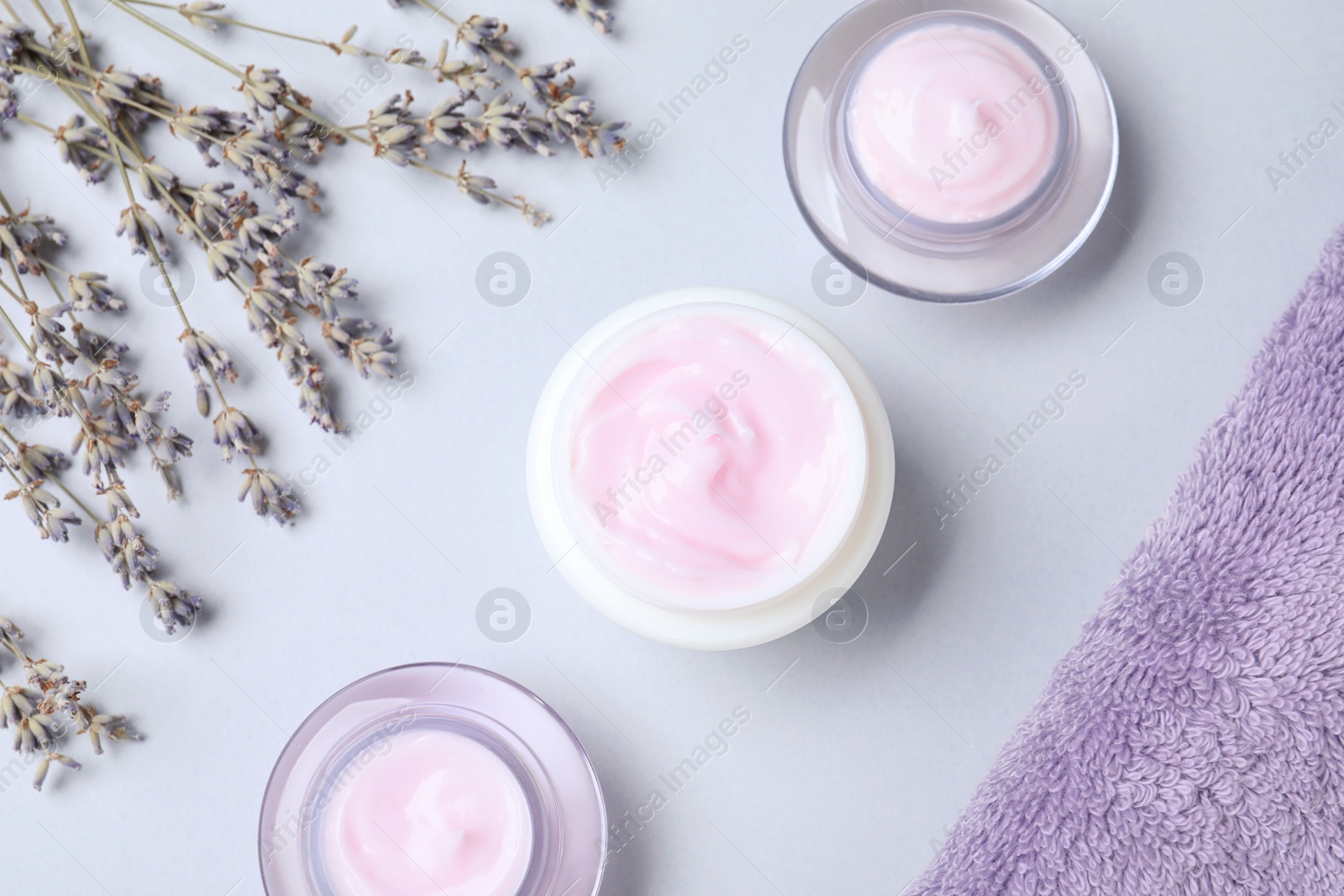 Photo of Flat lay composition with jars of cream on white background