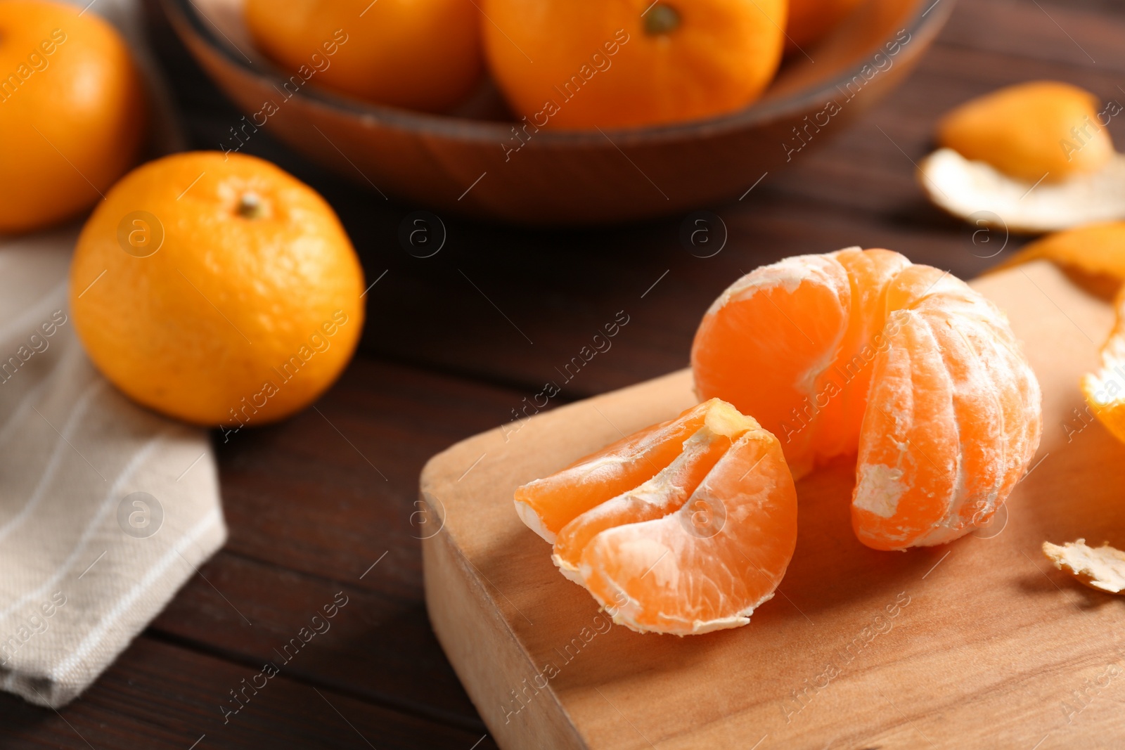 Photo of Fresh tangerines on wooden table. Citrus fruit