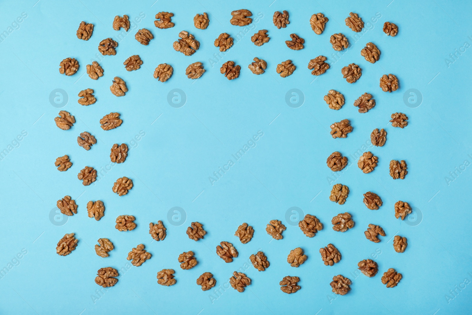Photo of Flat lay composition with tasty walnuts and space for text on color background