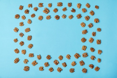 Photo of Flat lay composition with tasty walnuts and space for text on color background