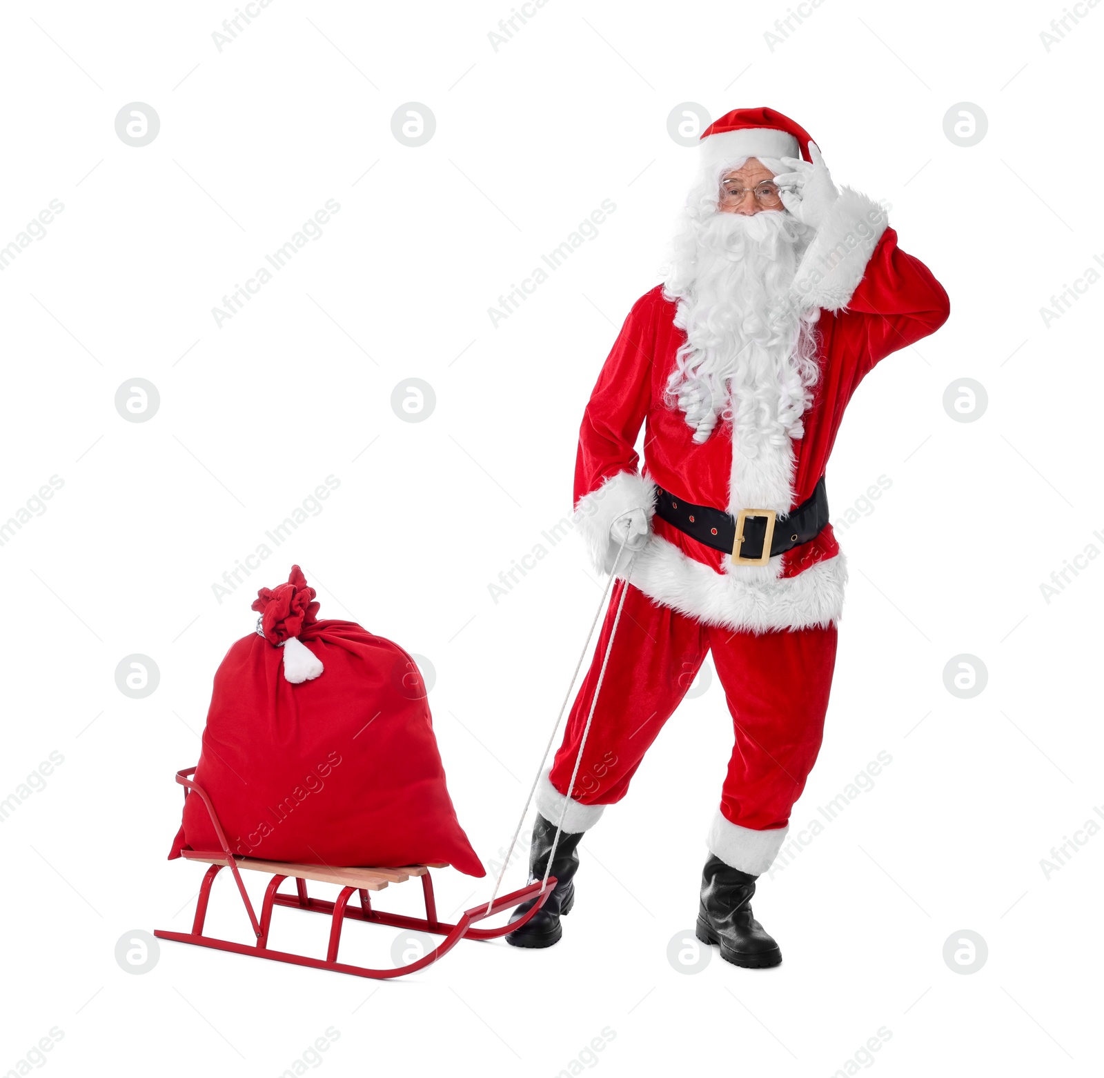 Photo of Man in Santa Claus costume with bag and sleigh on white background