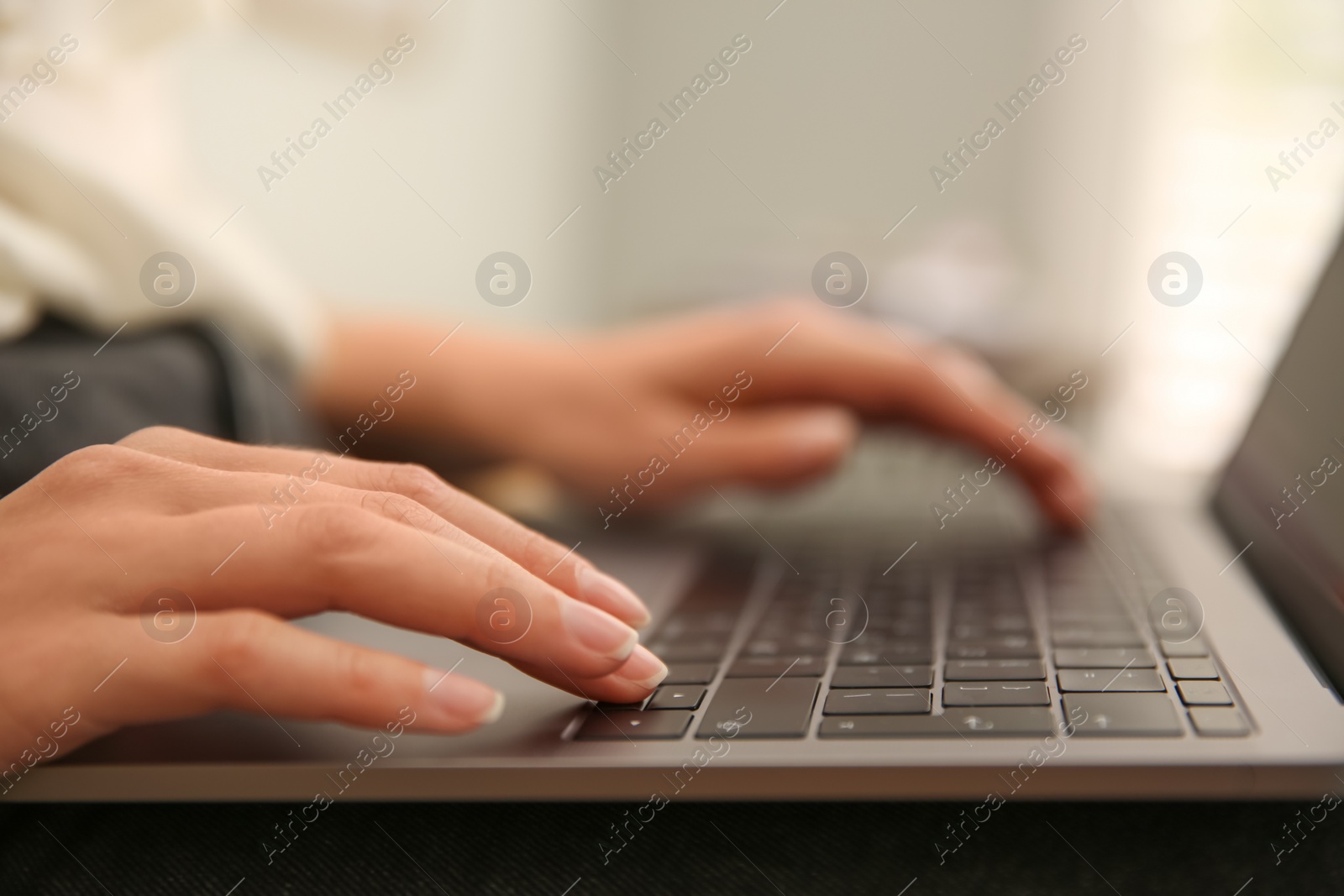 Photo of Woman working with modern laptop indoors, closeup