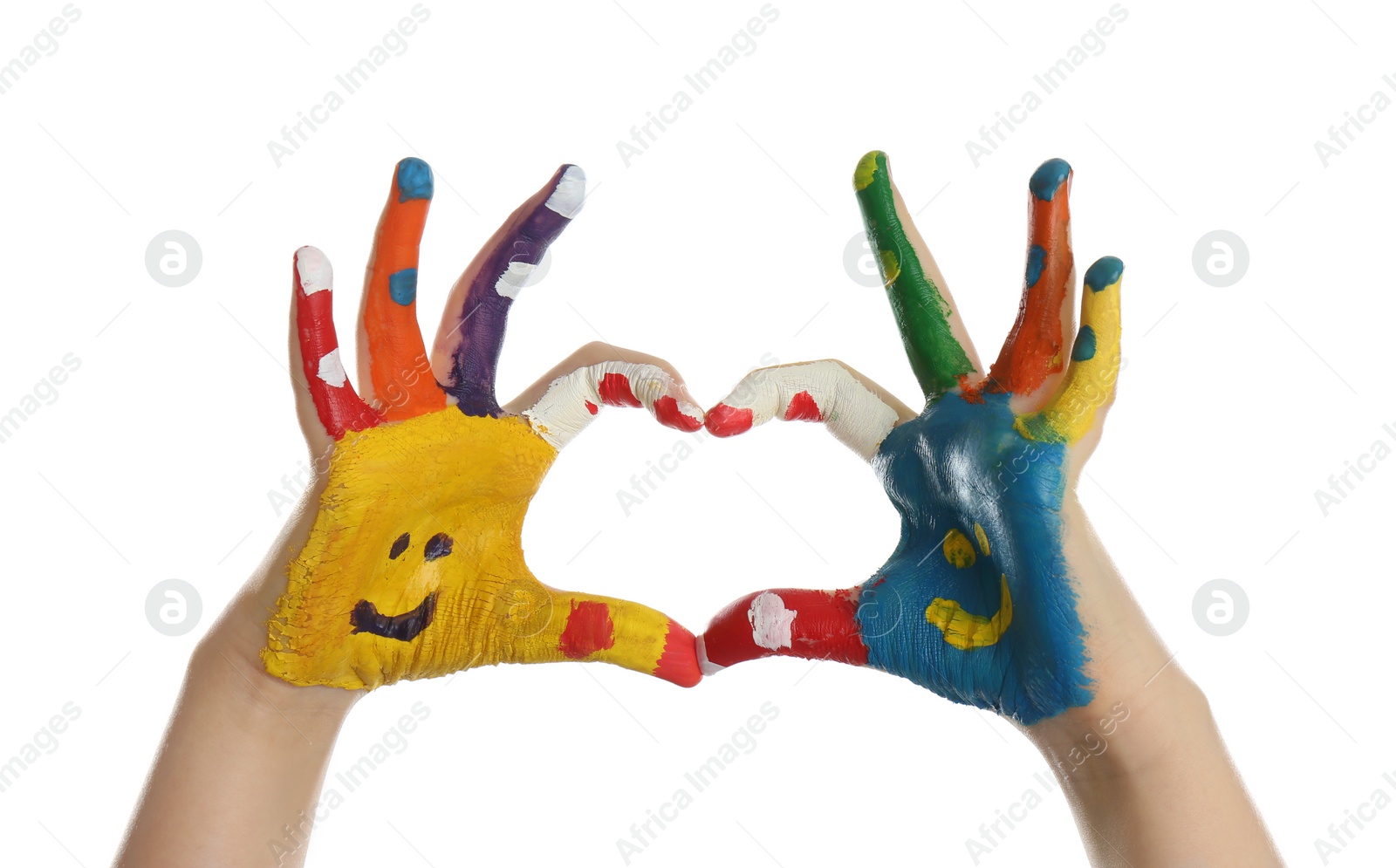 Photo of Kid with smiling faces drawn on palms showing heart gesture against white background, closeup