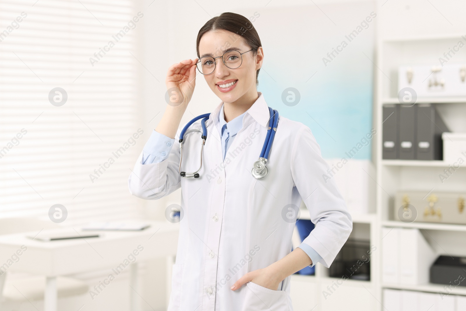 Photo of Medical consultant with glasses and stethoscope in clinic