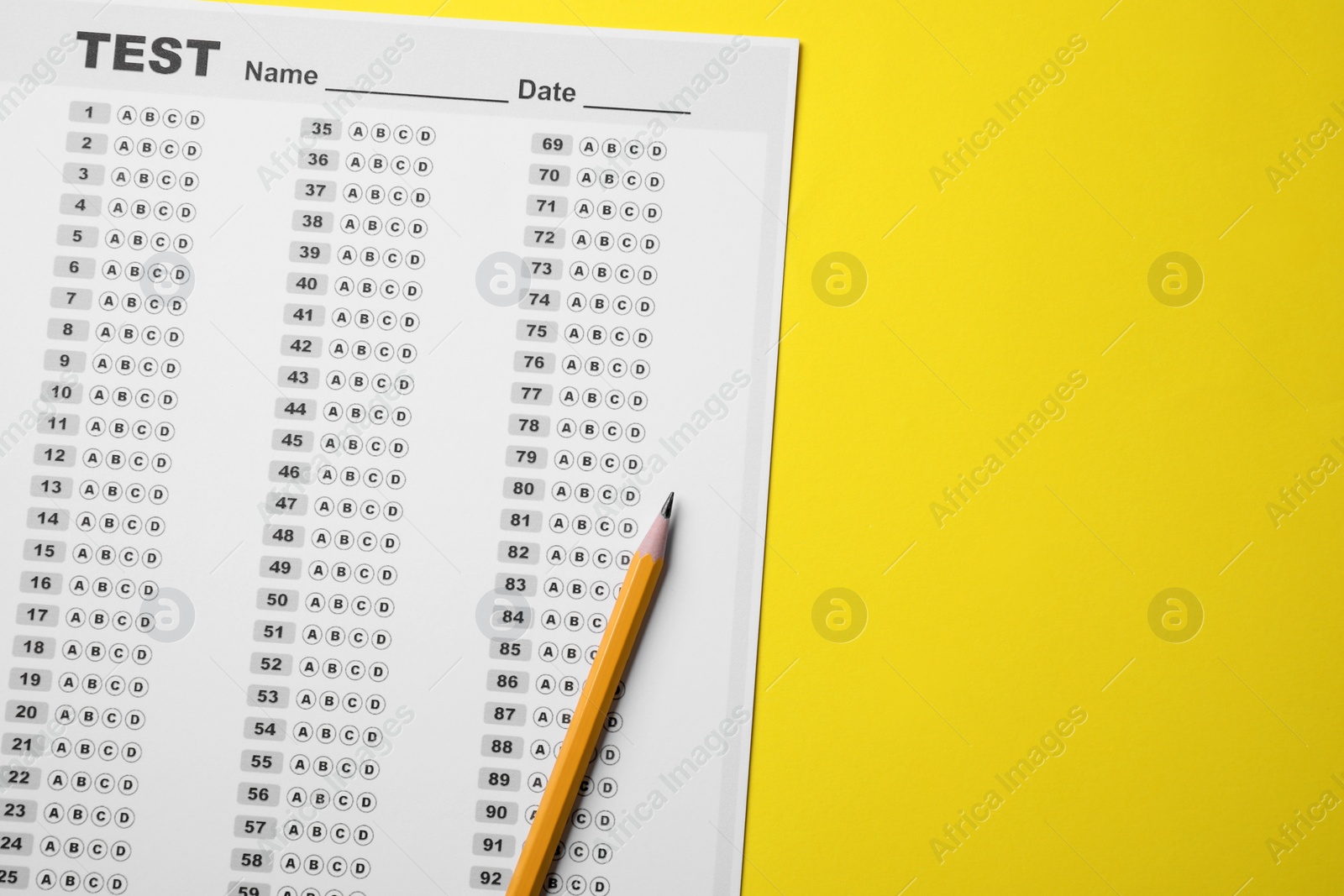 Photo of Answer sheet and pencil on yellow background, flat lay with space for text. Student passing exam
