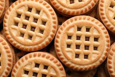 Photo of Tasty sandwich cookies with cream as background, top view