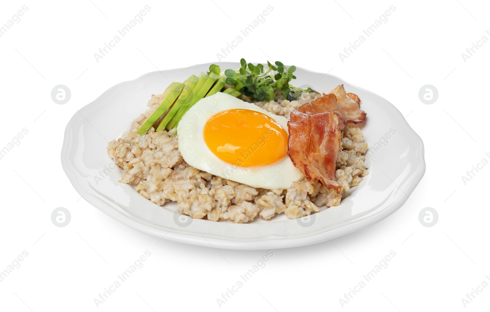 Photo of Tasty boiled oatmeal with fried egg, avocado and bacon isolated on white