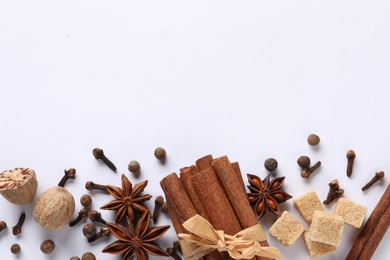 Photo of Different spices and nuts on white table, flat lay. Space for text