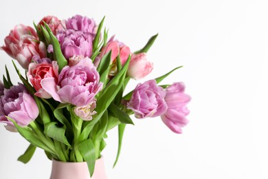 Photo of Beautiful bouquet of colorful tulip flowers on white background, closeup. Space for text