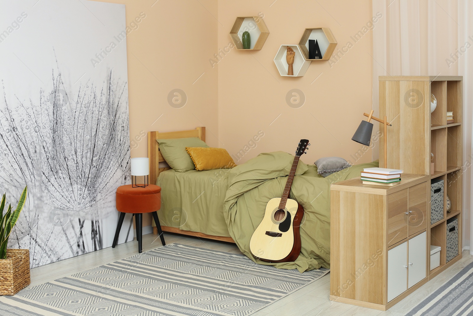 Photo of Stylish teenager's room interior with comfortable bed and guitar