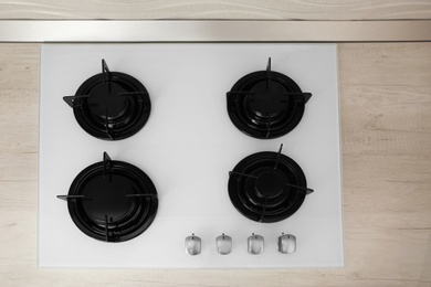 Photo of Modern built-in gas cooktop, top view. Kitchen appliance