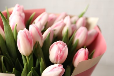 Beautiful bouquet of fresh pink tulips on light background, closeup