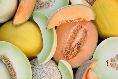 Photo of Different types of tasty ripe melons as background, top view