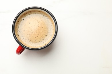 Cup of aromatic coffee on white table, top view. Space for text