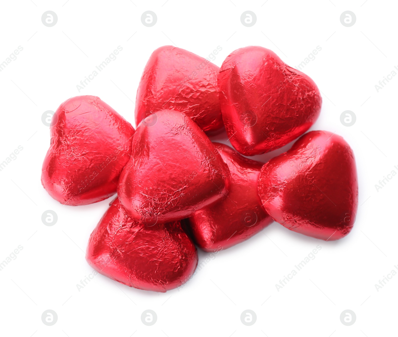 Photo of Heart shaped chocolate candies in red foil on white background, top view