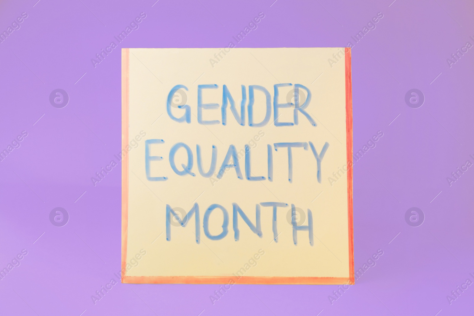 Photo of Card with text Gender Equality Month on violet background