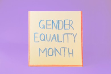 Photo of Card with text Gender Equality Month on violet background