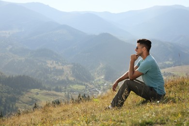 Man enjoying beautiful mountain landscape on sunny day