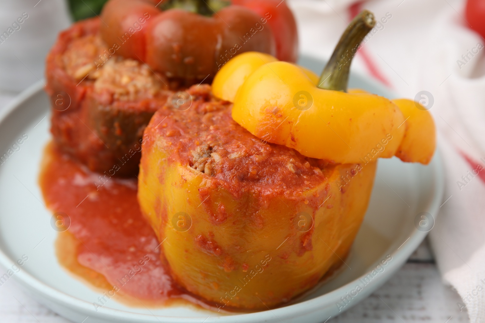 Photo of Delicious stuffed bell peppers on white wooden table, closeup