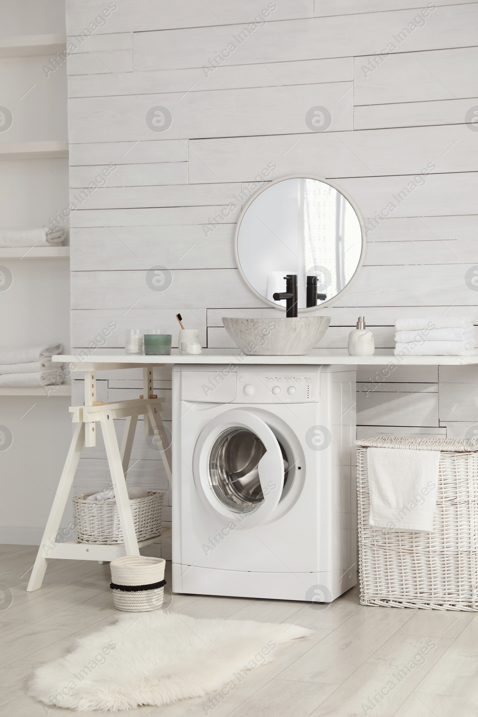 Photo of Stylish bathroom interior with modern washing machine