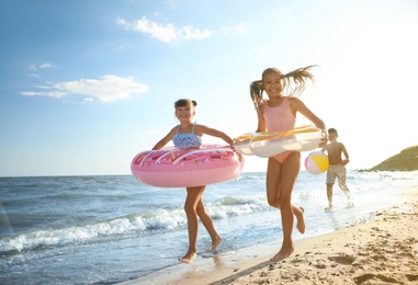 Cute children enjoying sunny day at beach. Summer camp