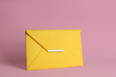 Photo of Stylish woman's bag on light pink background