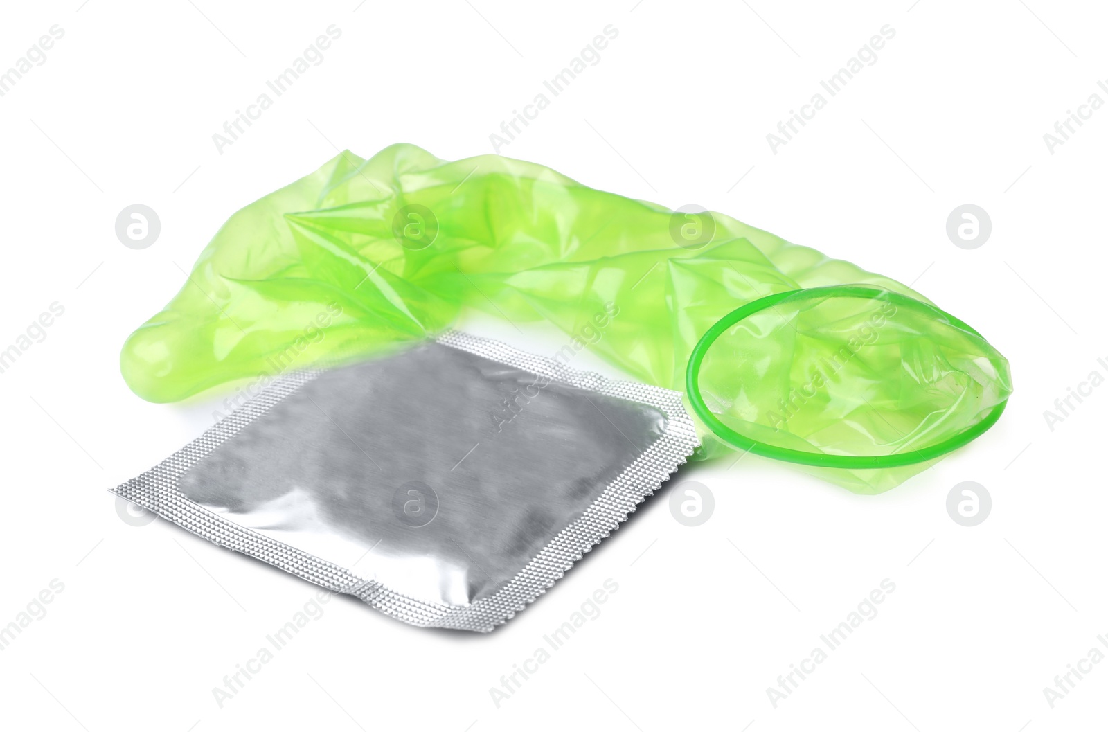 Image of Unrolled green condom and package on white background. Safe sex