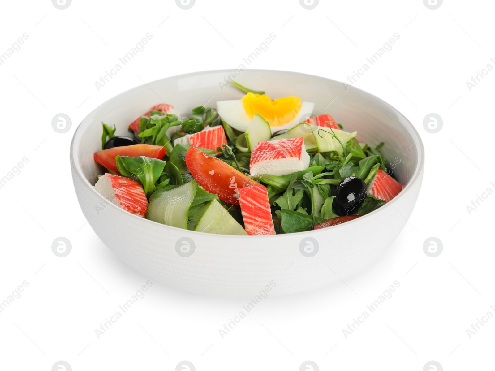 Photo of Delicious crab stick salad in bowl isolated on white