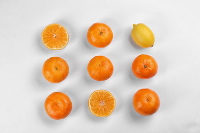 Photo of Flat lay composition with tangerines and lemon on white background