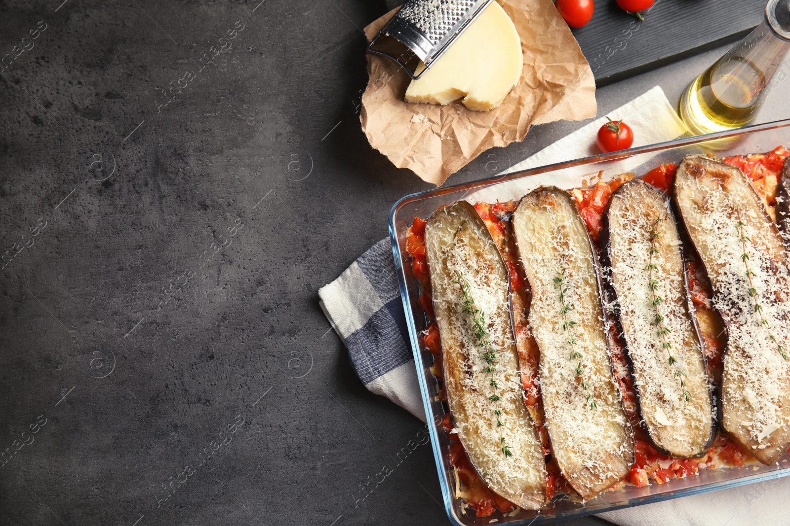 Photo of Flat lay composition with baked eggplant, tomatoes and cheese in dishware on table. Space for text