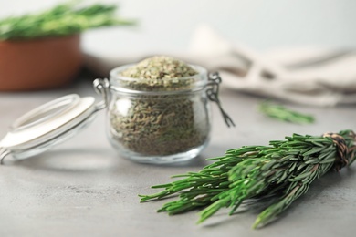 Fresh twigs and dried rosemary on grey table