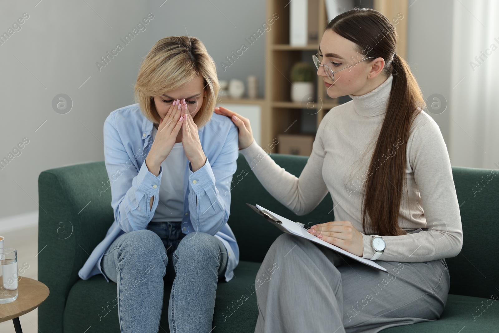 Photo of Psychotherapist working with patient on sofa in office