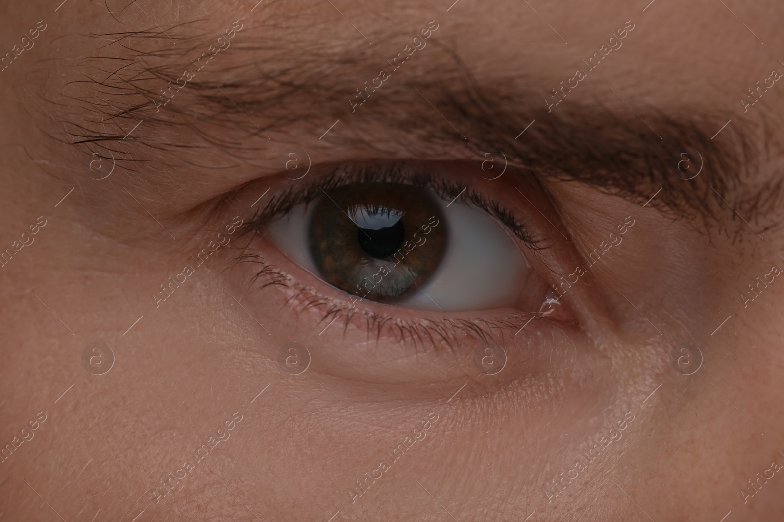 Photo of Evil eye. Man with scary eyes, closeup view