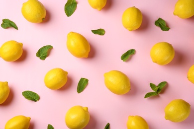 Photo of Flat lay composition with fresh ripe lemons and mint leaves on color background