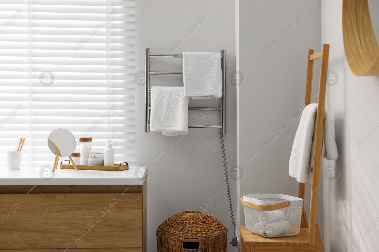 Photo of Stylish bathroom interior with heated towel rail and vanity