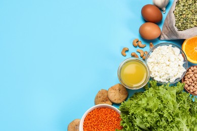 Photo of Food high in calcium. Flat lay composition with different products on light blue background, space for text
