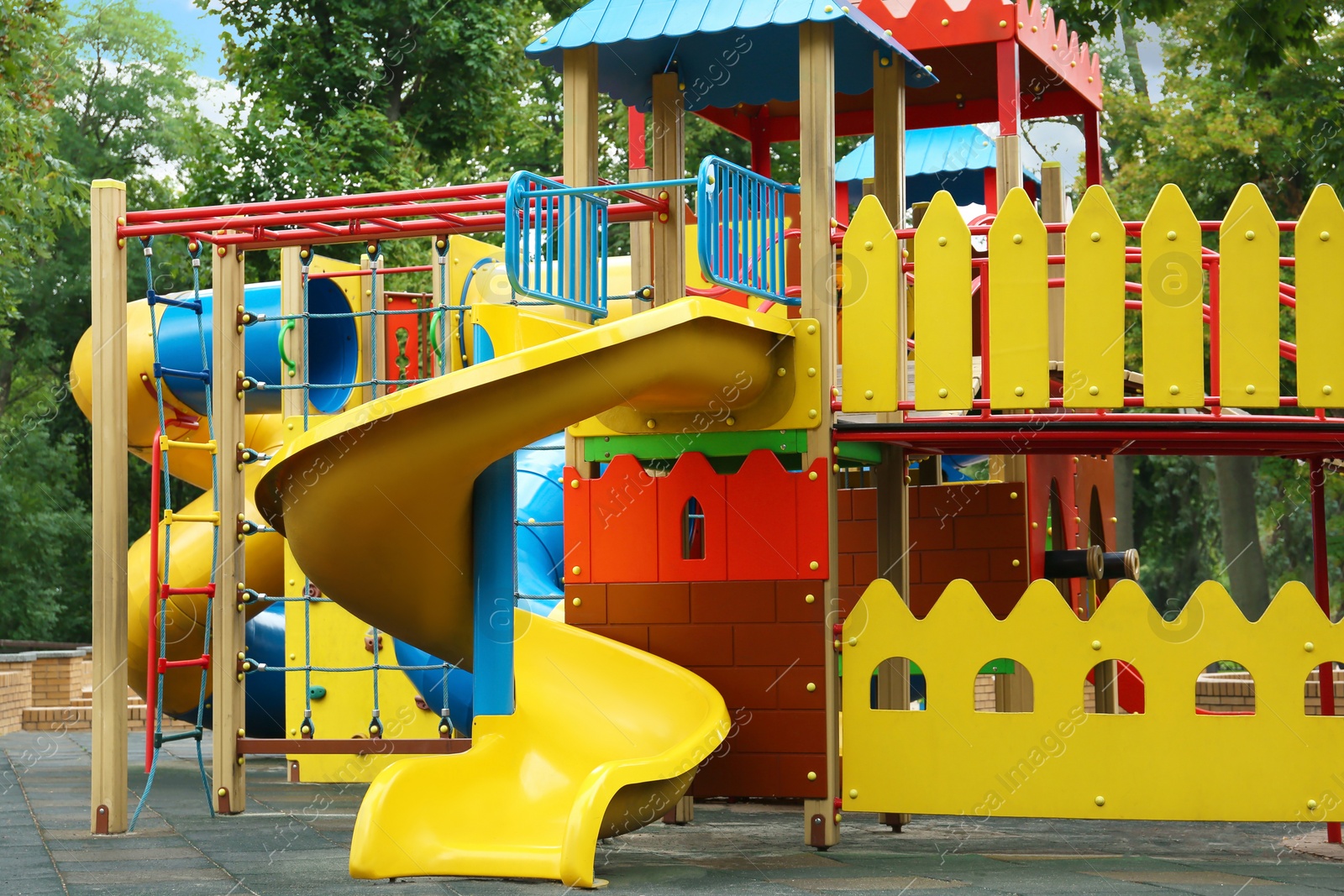 Photo of New colorful castle playhouse with slide on children's playground