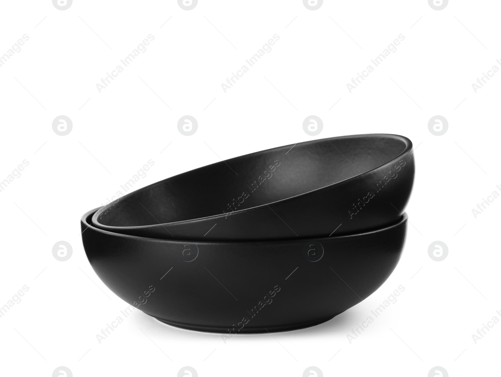 Photo of New black ceramic bowls on white background