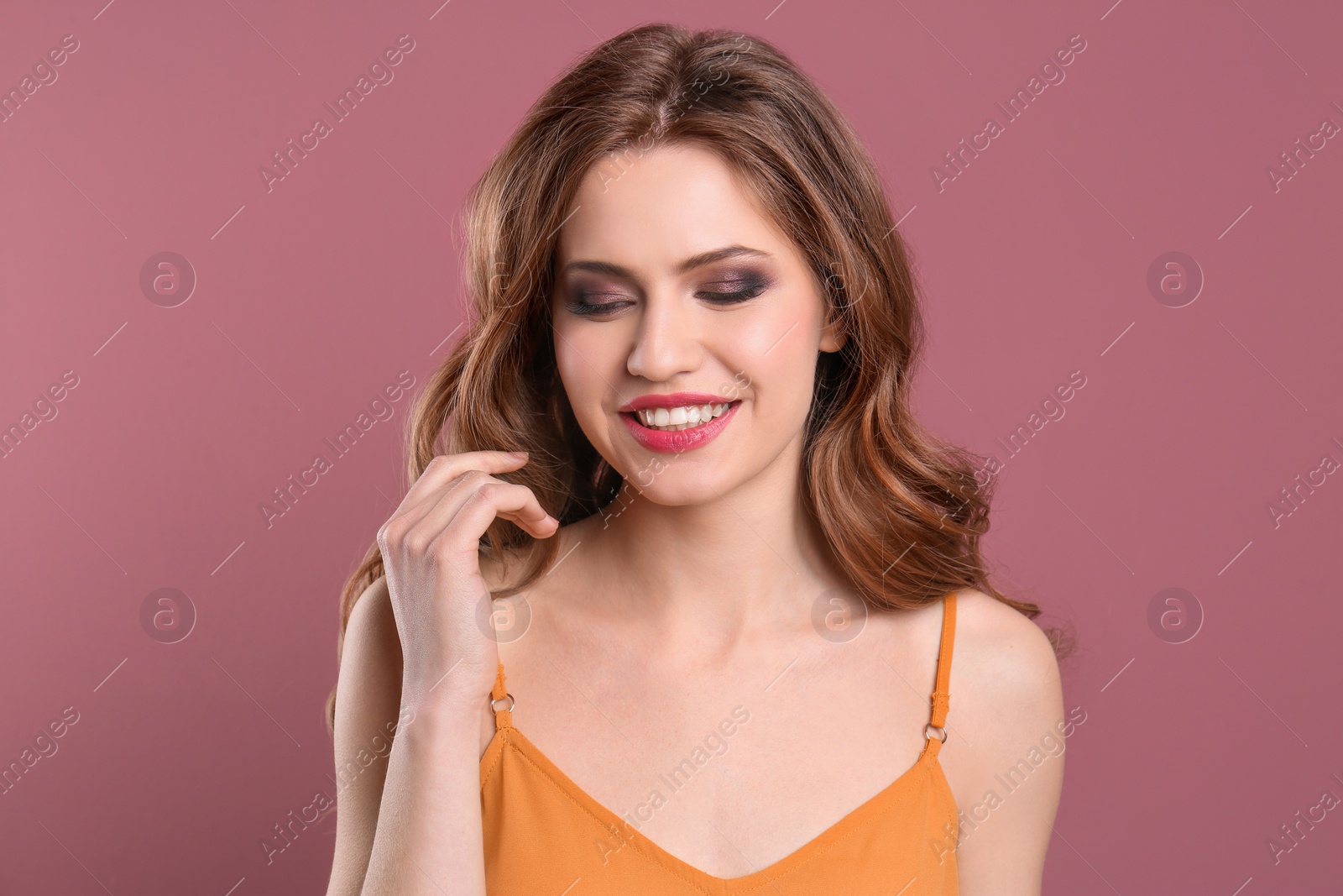 Photo of Portrait of young woman with long beautiful hair on color background