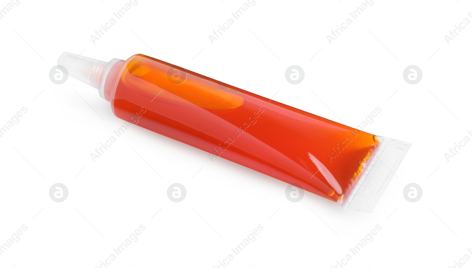 Photo of Tube with orange food coloring on white background