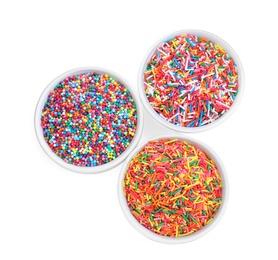 Photo of Colorful sprinkles in bowls on white background, top view. Confectionery decor