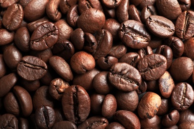 Roasted coffee beans as background, top view