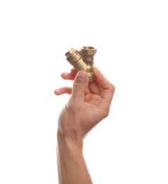 Male plumber holding pipe fitting on white background, closeup