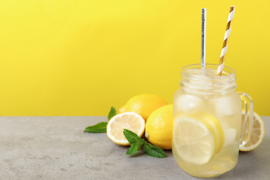 Photo of Natural freshly made lemonade with mint on light grey table. Summer refreshing drink