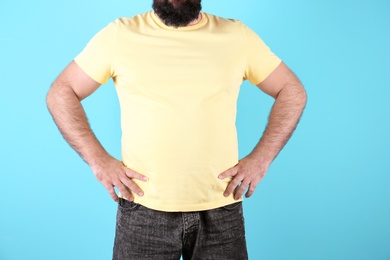 Photo of Fat man on color background, closeup. Weight loss