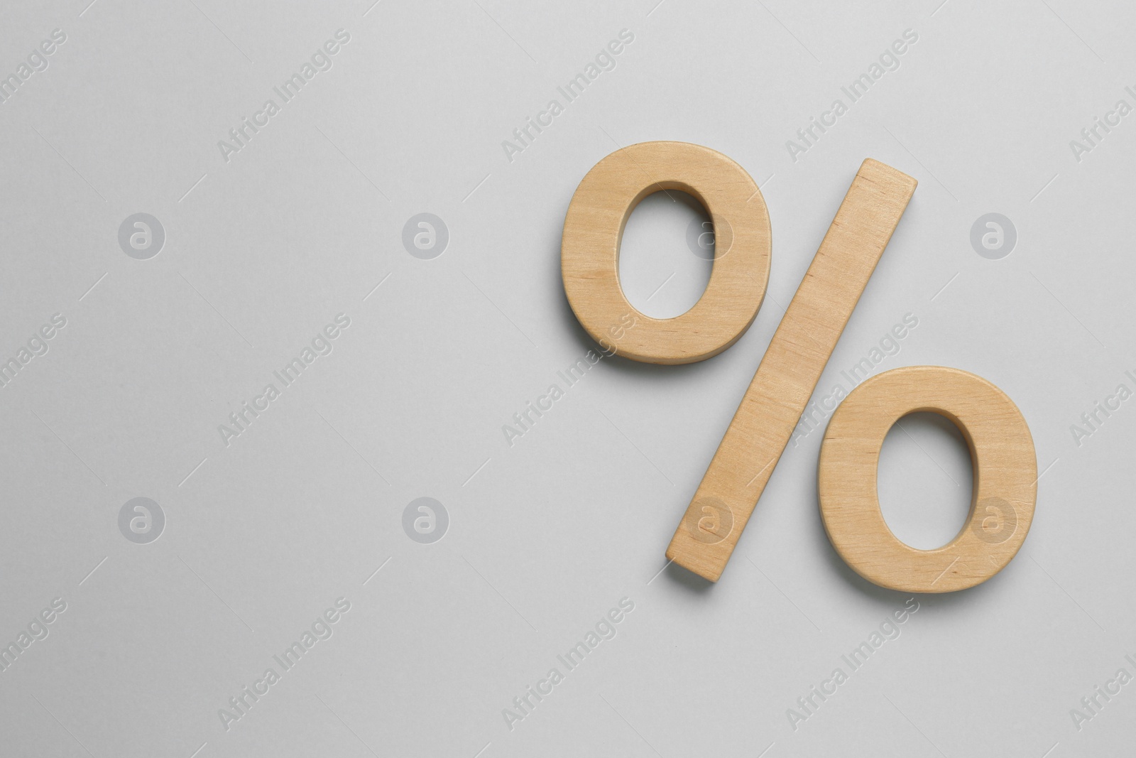 Photo of Wooden percent sign on grey background, flat lay. Space for text