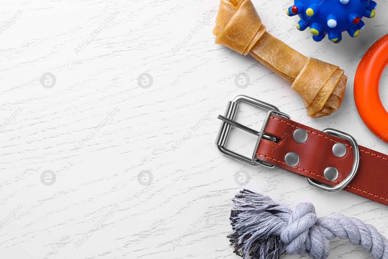 Photo of Flat lay composition with dog collar and different accessories on white wooden table, space for text